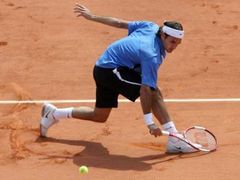 Švýcar Roger Federer odvrací míč z rakety Rafaela Nadala ve finále Roland Garros.