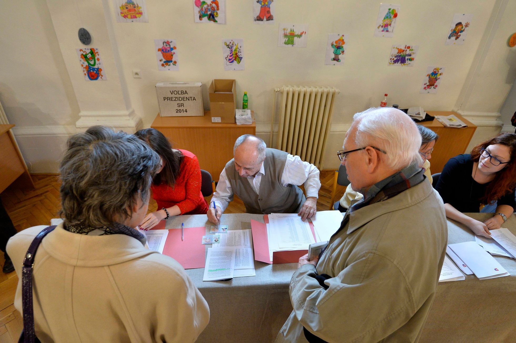Members of an election committee prepare ballots for voters at a polling station during the first round presidential elections in Bratislava