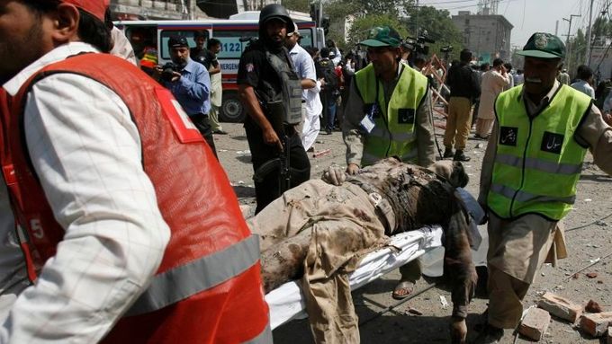 Záchranáři odnášejí z místa pumového útoku v Láhauru tělo jednoho ze zabitých pákistánských policistů