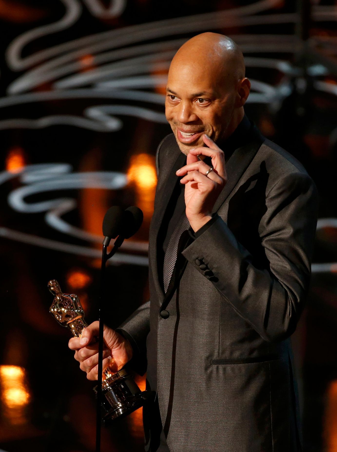 John Ridley accepts the Oscar for adapted screenplay for &quot;12 Years a Slave&quot; at the 86th Academy Awards in Hollywood
