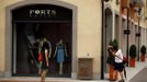 A man takes a photograph of a woman outside a fashion store in the Florentia Village in the district of Wuqing, located on the outskirts of the city of Tianjin June 13, 2012. The shopping center, which covers an area of some 200,000 square meters, was constructed on a former corn field at an estimated cost of US$220 million and copies old Italian-style architecture with Florentine arcades, a grand canal, bridges, and a building that resembles a Roman Coliseum. REUTERS/David Gray (CHINA - Tags: SOCIETY BUSINESS) Published: Čer. 13, 2012, 5:52 odp.