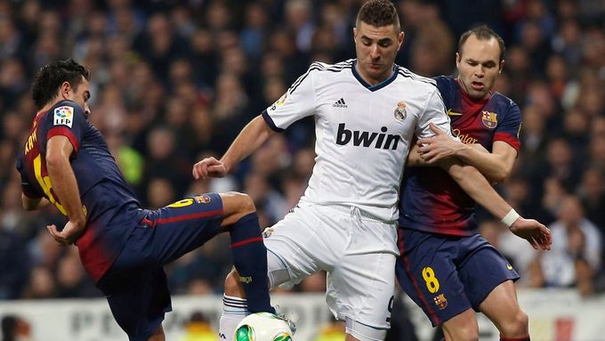 Xavi a Iniesta v souboji s Karimem Benzemou.