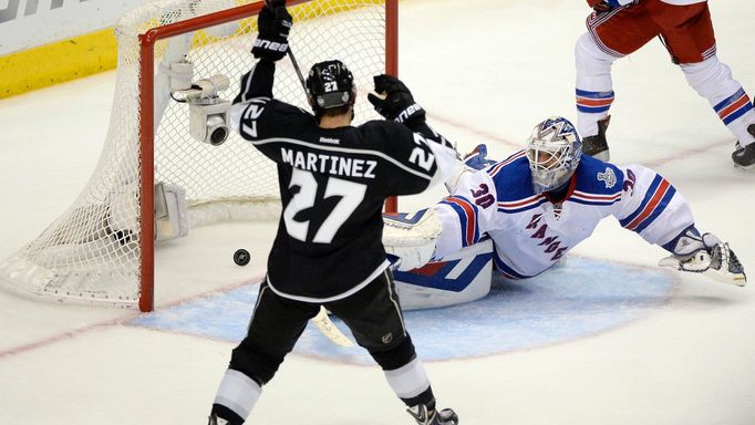 Jun 13, 2014; Los Angeles, CA, USA; Los Angeles Kings defenseman Alec Martinez (27) scores the game-winning goal past New York Rangers goalie Henrik Lundqvist (30) during