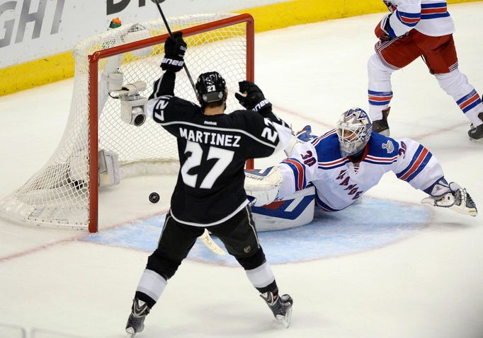 Jun 13, 2014; Los Angeles, CA, USA; Los Angeles Kings defenseman Alec Martinez (27) scores the game-winning goal past New York Rangers goalie Henrik Lundqvist (30) during