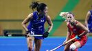 Olympic Hockey Centre - Rio de Janeiro, Brazil - 10/08/2016. Mayumi Ono (JPN) of Japan (L) competes with Katie Bam (USA) of USA.