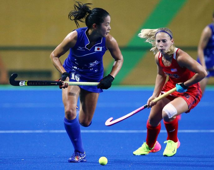 Olympic Hockey Centre - Rio de Janeiro, Brazil - 10/08/2016. Mayumi Ono (JPN) of Japan (L) competes with Katie Bam (USA) of USA.