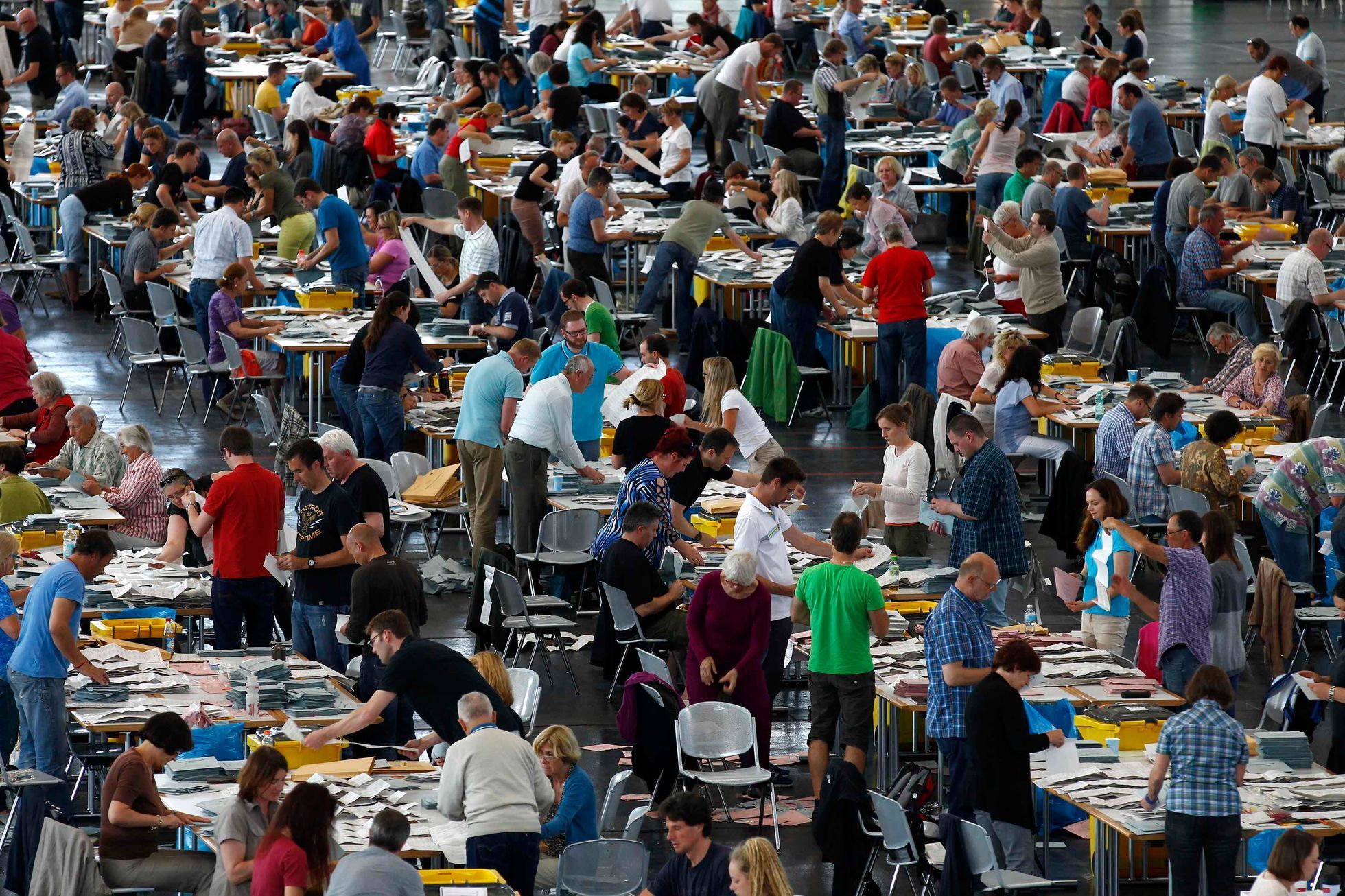 Electoral officials sort ballot papers after conclusion of voting in European Parliament elections in Munich