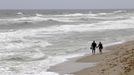 A couple walks on the beach after lifeguards closed the area for swimming as winds from Hurricane Sandy begin to affect weather in Deerfield Beach, Florida October 25, 2012. REUTERS/Joe Skipper (UNITED STATES - Tags: ENVIRONMENT) Published: Říj. 25, 2012, 4:36 odp.