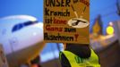 A member of German air carrier Lufthansa cabin crew union "UFO" holds a placard that reads "Our crane is not a goose to fleece" during a strike at the Fraport airport in Frankfurt, September 4, 2012. Lufthansa passengers face widespread flight disruption after cabin crew representatives said they continue a series of strikes over pay and cost-cutting measures at Germany's largest airline. The UFO union, which represents around two-thirds of Lufthansa's 19,000 cabin crew, late on Thursday called on its members to strike from 0400 GMT to 1500 GMT on Tuesday in Frankfurt and Berlin. REUTERS/Kai Pfaffenbach (GERMANY - Tags: BUSINESS EMPLOYMENT CIVIL UNREST TRANSPORT) Published: Zář. 4, 2012, 5:45 dop.