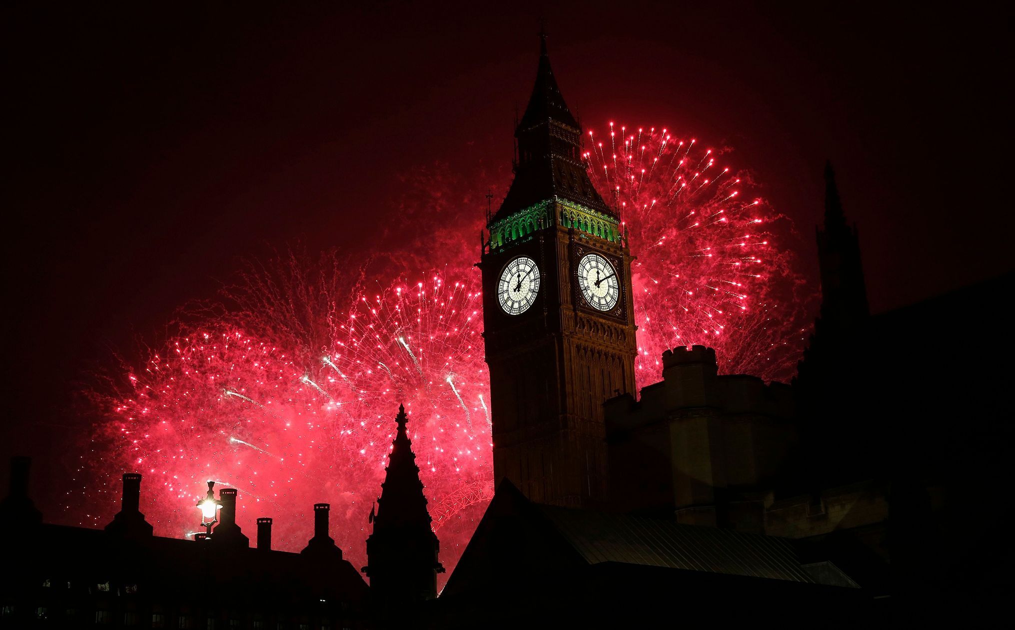 Fireworks explode behind the Houses of Parliament and Big Ben on the River Thames during New Year's celebrations in London