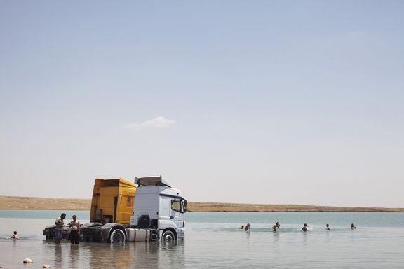 Civilisté plavou v mosulské přehradní nádrži.