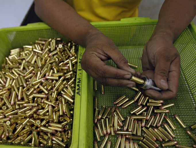 A gun factory worker fits a bullet on a chamber of a revolver at Shooters Arms, a gun manufacturing company exporting different kinds of weapons to other countries, in Cebu city in central Philippines July 6, 2012. In the Philippines, they vote with their trigger fingers. Elections mean big business for illegal gunsmiths, who are looking forward to 2013 mid-term polls. With election-related violence commonplace, the Philippines imposes a ban on the carrying of guns for six months, from campaigning to the proclamation of winners. Picture taken July 6, 2012. To match Feature PHILIPPINES-GUNS/ REUTERS/Erik De Castro (PHILIPPINES - Tags: SOCIETY POLITICS BUSINESS CRIME LAW) Published: Čec. 29, 2012, 1:48 dop.