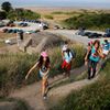 Youths hike up a hill past an old German bunker overlooking the former D-Day landing zone of Omaha Beach near Colleville sur Mer