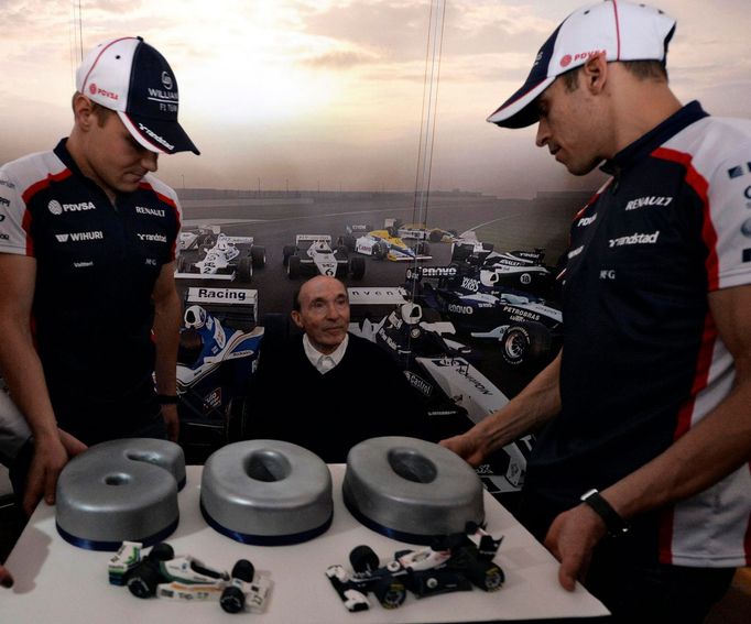 Williams Formula One team founder Frank Williams (C) poses with drivers Valtteri Bottas (L) and Pastor Maldonado during a party marking the team's 600th race, ahead of th