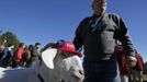 A goat named Izak and his owner Bill Higgins walk past a line of supporters for U.S. President Barack Obama outside the Dover Elks Club Lodge before the start of a campaign event with former U.S. President Bill Clinton in Dover, New Hampshire November 4, 2012. REUTERS/Jessica Rinaldi (UNITED STATES - Tags: POLITICS ELECTIONS USA PRESIDENTIAL ELECTION ANIMALS) Published: Lis. 4, 2012, 8:20 odp.