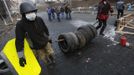 Anti-government protesters carry tyres to a barricade in Kiev February 21, 2014.