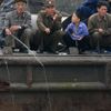 Rybáři ve městě Sinujiu na severokorejské straně řeky Ja-lu, která odděluje Severní Koreu od Číny.
