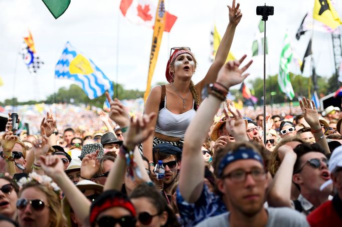 A reveller dances as George Ezra performs on the Pyramid stage at Worthy Farm in Somerset during the Glastonbury Festival