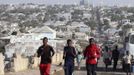 Somali athletes run along a street as they train during preparations for the 2012 London Olympic Games in Somalia's capital Mogadishu, in this March 14, 2012 file photo. Training in a bullet-riddled stadium where the remains of a rocket propelled grenade lies discarded on the track's edge counts as progress for Somali Olympic hopeful Mohamed Hassan Mohamed. A year ago, Mogadishu's Konis stadium was a base for Islamist militants and a work out meant at times running through the streets, dodging gun-fire and mortar shells in one of the world's most dangerous cities. To match OLY-SOMALIA-HOPES/ REUTERS/Feisal Omar/Files (SOMALIA - Tags: SPORT ATHLETICS SOCIETY OLYMPICS) Published: Čer. 11, 2012, 7:03 dop.