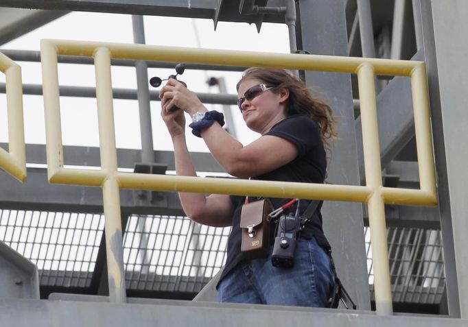 Kennedy Space Center safety officer checks the wind with an anemometer pace after mating of the space shuttle Discovery to a NASA 747 aircraft was delayed for high winds at Kennedy Space Center in Cape Canaveral