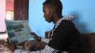 Somali athlete Abdullah Bare Kuulow reads the newspapers after a training session during their preparations for the 2012 London Olympic Games in Somalia's capital Mogadishu in this March 14, 2012 file photo. Training in a bullet-riddled stadium where the remains of a rocket propelled grenade lies discarded on the track's edge counts as progress for Somali Olympic hopeful Mohamed Hassan Mohamed. A year ago, Mogadishu's Konis stadium was a base for Islamist militants and a work out meant at times running through the streets, dodging gun-fire and mortar shells in one of the world's most dangerous cities. To match OLY-SOMALIA-HOPES/ REUTERS/Feisal Omar/Files (SOMALIA - Tags: SPORT ATHLETICS SOCIETY OLYMPICS) Published: Čer. 11, 2012, 6:41 dop.