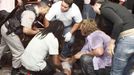 A policeman and rescue workers help a man in front of the Kiss nightclub in the southern city of Santa Maria, 187 miles (301 km) west of the state capital of Porto Alegre, in this picture taken by Agencia RBS, January 27, 2013. At least 200 people were killed in the nightclub fire in southern Brazil on Sunday after a band's pyrotechnics show set the building ablaze, and fleeing patrons were unable to find the emergency exits, local officials said. Bodies were still being removed from the Kiss nightclub in the southern city of Santa Maria, Major Gerson da Rosa Ferreira, who was leading rescue efforts at the scene for the military police, told Reuters. Local officials said 180 people were confirmed dead, and Ferreira said the death toll would rise above 200. He said the victims died of asphyxiation, or from being trampled, and that there were possibly as many as 500 people inside the club when the fire broke out at about 2:30 a.m. REUTERS/Germano Roratto/Agencia RBS (BRAZIL - Tags: DISASTER TPX IMAGES OF THE DAY) NO SALES. NO ARCHIVES. BRAZIL OUT. NO COMMERCIAL OR EDITORIAL SALES IN BRAZIL Published: Led. 27, 2013, 8:46 odp.