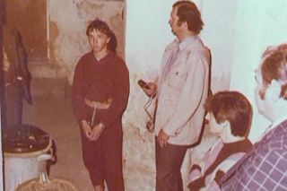 Jiří Straka (v poutech) při rekonstrukci poslední vraždy ve sklepě domu v Praze-Bubenči, léto 1985. Vyšetřovatelům popisuje detaily činu.