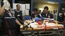 A woman, who was wounded during a fire at Boate Kiss nightclub, is transferred from a hospital in Santa Maria to receive treatment at Porto Alegre hospital in the southern city of Santa Maria, 187 miles (301 km) west of the state capital Porto Alegre early January 28, 2013. The nightclub fire killed at least 232 people in Santa Maria early on Sunday when a band's pyrotechnics show set the building ablaze and fleeing partygoers stampeded toward blocked and overcrowded exits in the ensuing panic, officials said. REUTERS/Edison Vara (BRAZIL - Tags: DISASTER HEALTH TPX IMAGES OF THE DAY) Published: Led. 28, 2013, 4:58 dop.