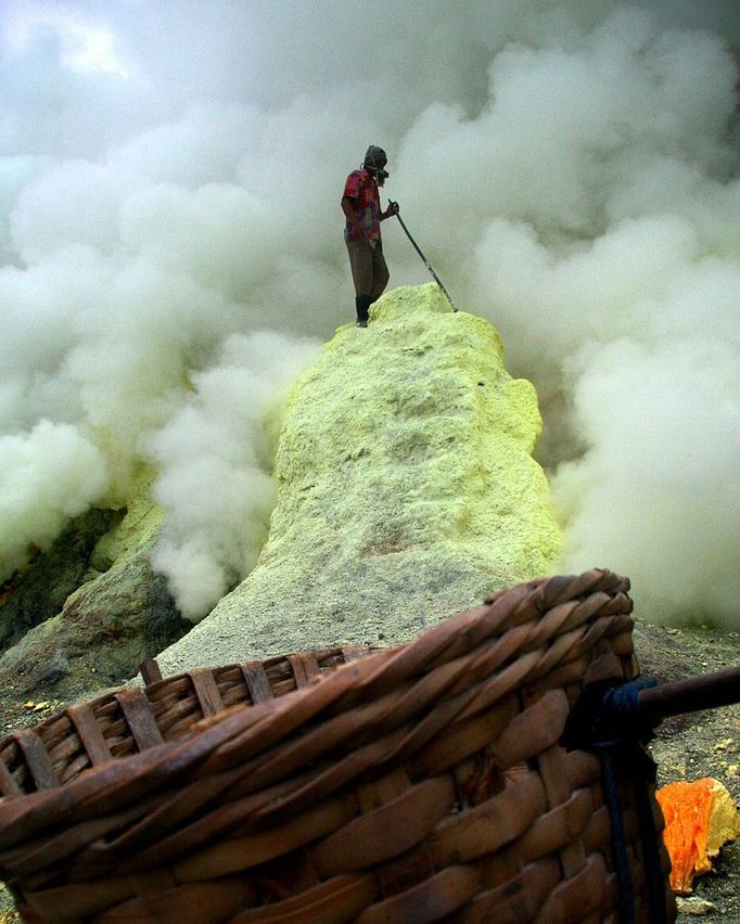 An Indonesian sulphur miner collects sulphur from the crater atop the Ijen volcano in Banyuwangi, on East Java, on December 15, 2009. An active vent at the Ijen volcano 2