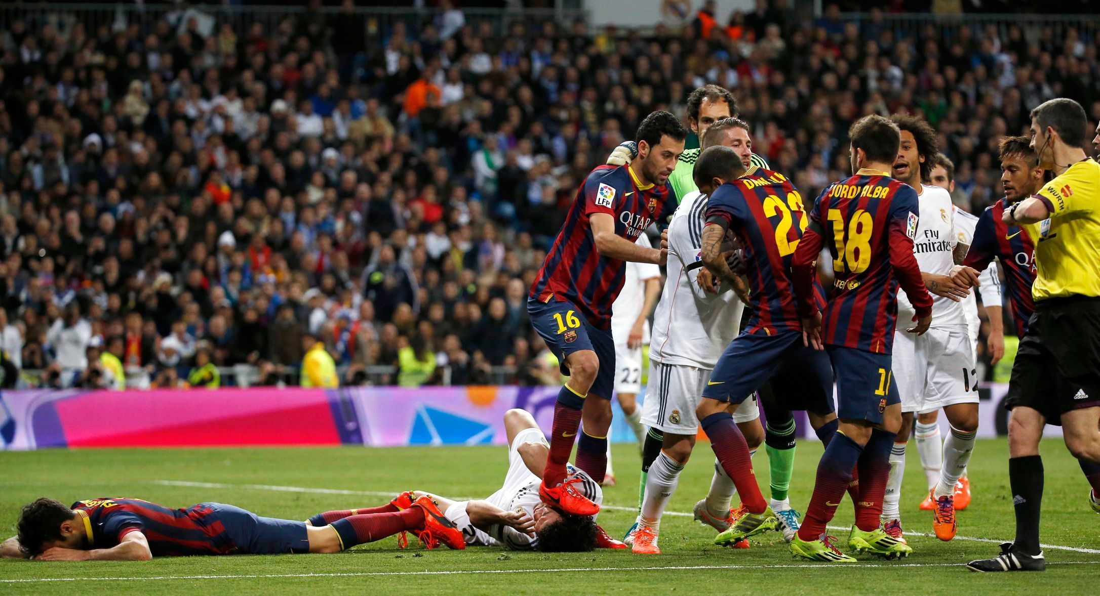 Barcelona's Busquets steps on Real Madrid's Pepe after Lionel Messi's goal against Real Madrid during La Liga's second 'Clasico' soccer match of the season in Madrid