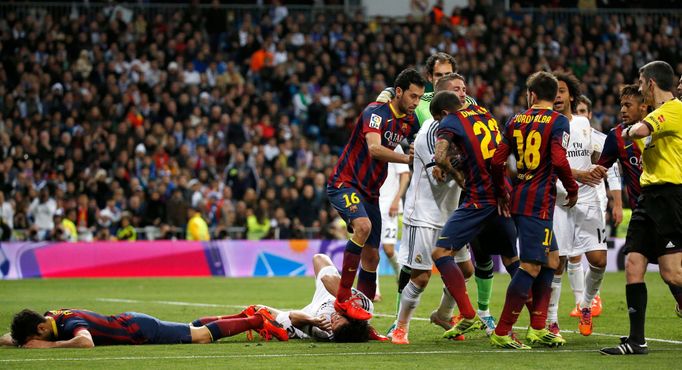 Barcelona's Busquets steps on Real Madrid's Pepe after Lionel Messi's goal against Real Madrid during La Liga's second 'Clasico' soccer match of the season in Madrid