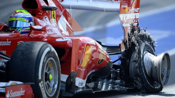 Ferrari Formula One driver Felipe Massa of Brazil enters the pit with a puncture during the British Grand Prix at the Silverstone race circuit, central England, June 30,