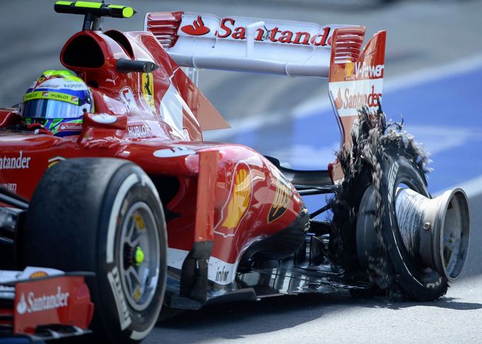 Ferrari Formula One driver Felipe Massa of Brazil enters the pit with a puncture during the British Grand Prix at the Silverstone race circuit, central England, June 30,