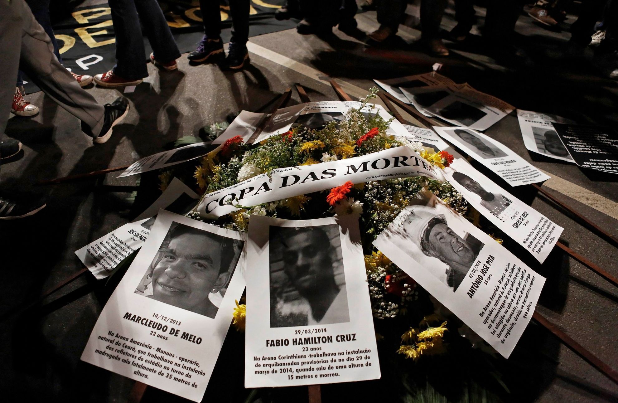 Flowers with pictures of dead workers are seen during protest against the 2014 World Cup, in Sao Paulo