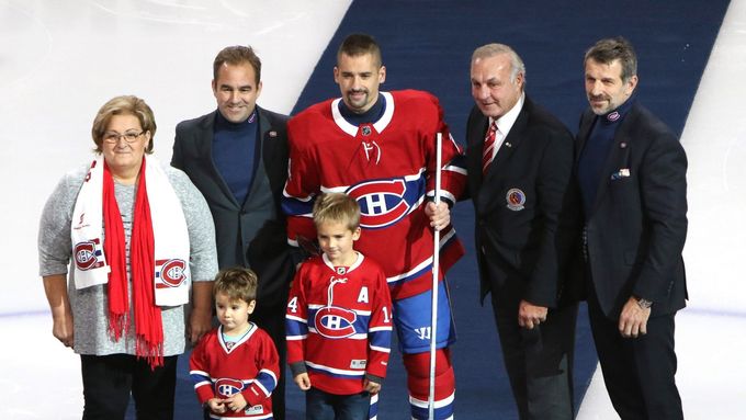 Tomáš Plekanec se stříbrnou hokejkou, kterou obdržel za 1000 zápasů v NHL. Společně s českým hokejistou jsou na fotce jeho maminka, synové, Guy Lefleur i Marc Bergevin.