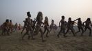 Naga Sadhus or Hindu holymen run to take a holy dip during the first "Shahi Snan" (grand bath) at the ongoing "Kumbh Mela", or Pitcher Festival, in the northern Indian city of Allahabad January 14, 2013. Upwards of a million elated Hindu holy men and pilgrims took a bracing plunge in India's sacred Ganges river to wash away lifetimes of sins on Monday, in a raucous start to an ever-growing religious gathering that is already the world's largest. REUTERS/Ahmad Masood (INDIA - Tags: RELIGION SOCIETY) TEMPLATE OUT Published: Led. 14, 2013, 8:37 dop.