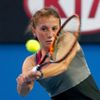 Annika Beck of Germany hits a return to Ana Ivanovic of Serbia during their women's singles match at the Australian Open 2014 tennis tournament in Melbourne