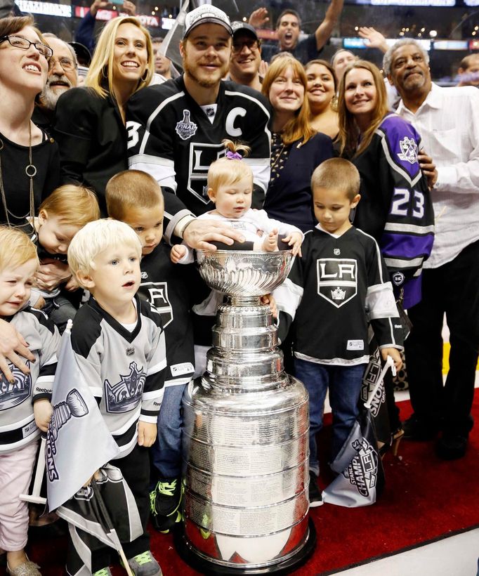 Los Angeles Kings' Dustin Brown puts his daughter Mackenzie in the Stanley Cup after the Kings' defeated the New York Rangers in Game 5 of their NHL Stanley Cup Finals ho