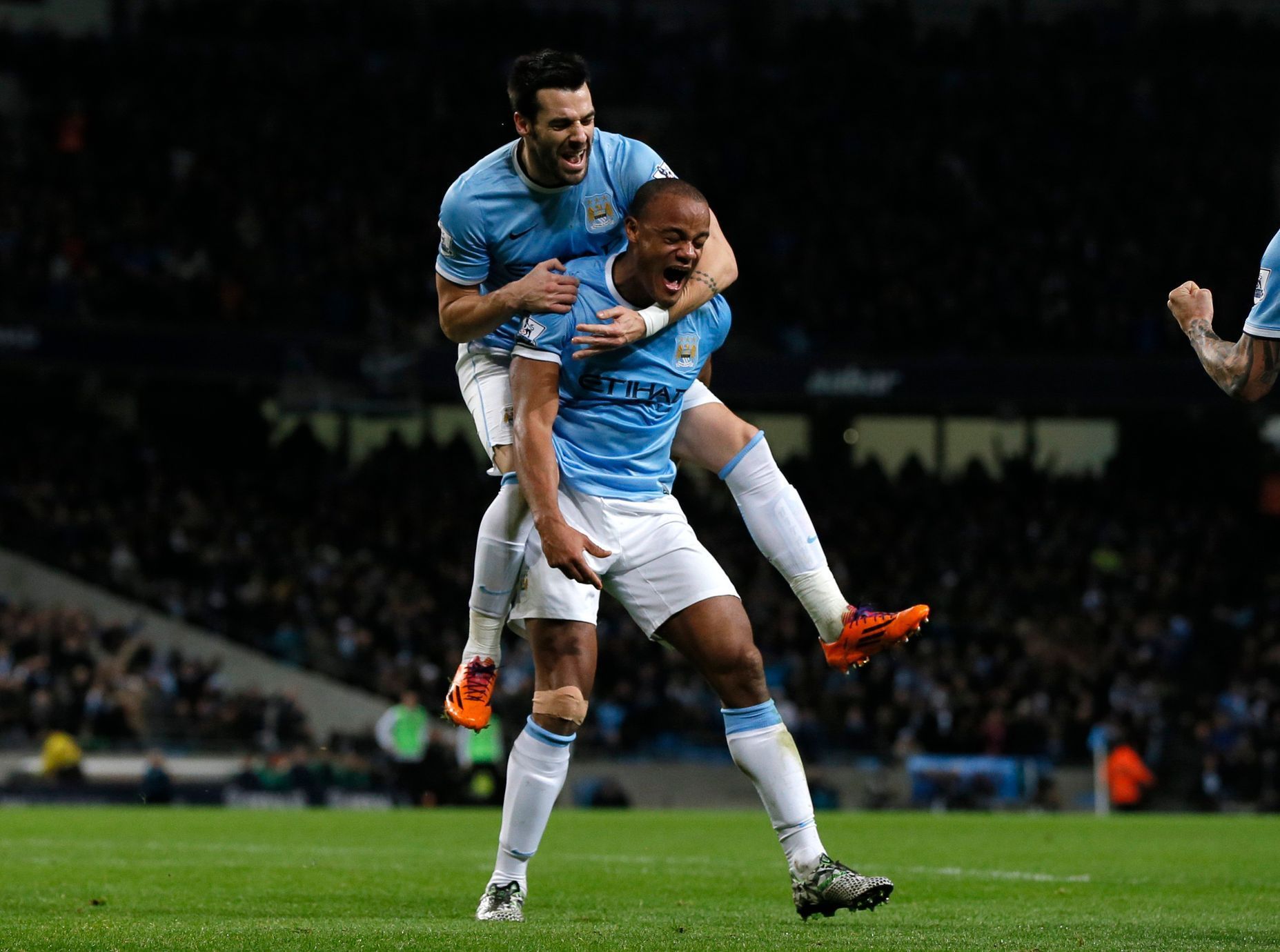 Manchester City's Kompany celebrates with teammate Negredo after scoring a goal against Liverpool during their English Premier League soccer match in Manchester