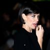 Cast member Lilly applies lipstick as she arrives for the world film premiere of &quot;The Hobbit: The Battle of the Five Armies&quot; at Leicester Square in central London
