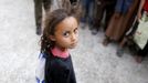 A girl waits for her family's ration at a food assistance center run by volunteers in Yemen's capital Sanaa July 1, 2015.