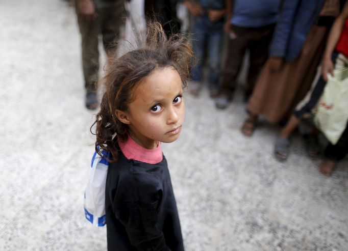 A girl waits for her family's ration at a food assistance center run by volunteers in Yemen's capital Sanaa July 1, 2015.