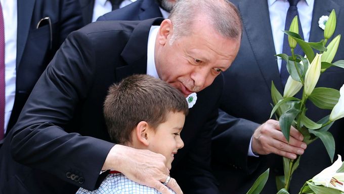 REFILE - QUALITY REPEAT Turkey's President Recep Tayyip Erdogan speaks to a boy at a convoy carrying remains of the Srebrenica genocide victims, in Sarajevo, Bosnia and H