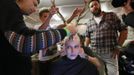 The TIGI creative team work backstage to mount antlers onto a model's head in the TIGI dressing room at the 30th anniversary of the Alternative Hair Show at the Royal Albert Hall in London October 14, 2012. REUTERS/Olivia Harris (BRITAIN - Tags: SOCIETY FASHION) Published: Říj. 15, 2012, 2:03 dop.