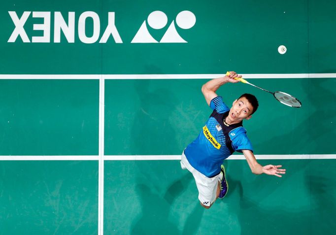 File photo of Malaysia's Lee Chong Wei hitting a return during his men's singles final match against Indonesia's Tommy Sugiarto at the Malaysian Open Super Series 2014 ba