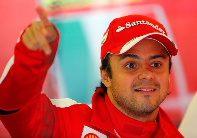 Ferrari Formula One driver Felipe Massa of Brazil speaks with his pit crew during the first practice session ahead of the British Grand Prix at the Silverstone Race circu