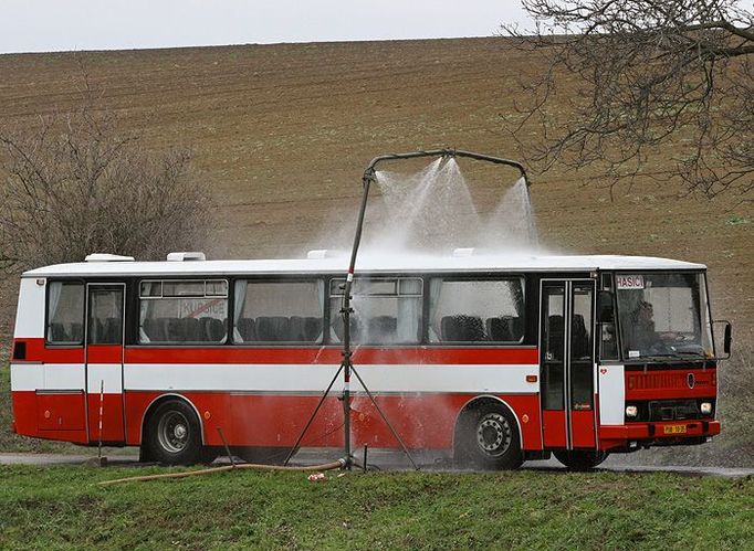 Autobusy s evakuovanými přijíždějí od Vémyslic do Kubšic, které už jsou za hranicemi takzvané zóny havarijního plánování. Musí projet několika branami, než se zbaví kontaminace.