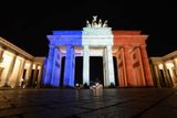 Slavné světové dominanty zářily v noci francouzskými národními barvami. Braniborská brána v Berlíně.