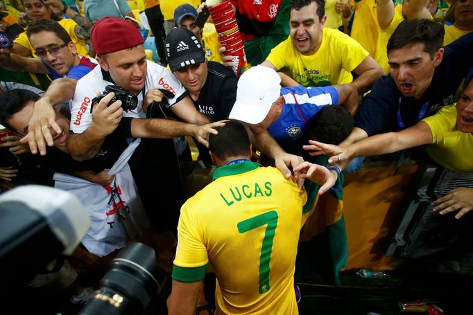 Fans congratulate Brazil's Lucas after winning their Confederations Cup final soccer match against Spain at the Estadio Maracana in Rio de Janeiro June 30, 2013. REUTERS/