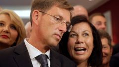 Miro Cerar, leader of the SMC, listens to his partner Vesna Arnsek after he seeing preliminary results of elections in Ljubljana